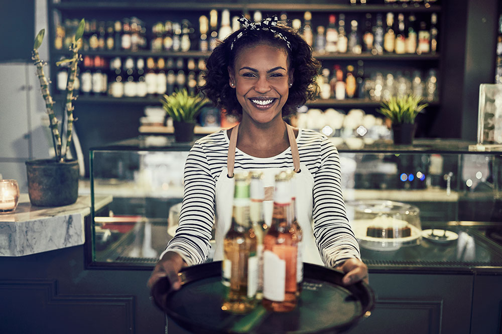 friendly-african-restaurant-server-holding-a-tray